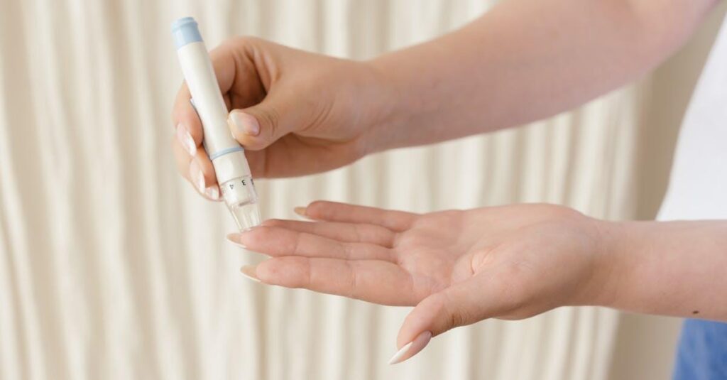 Close-up of hands using a glucometer for diabetes monitoring.